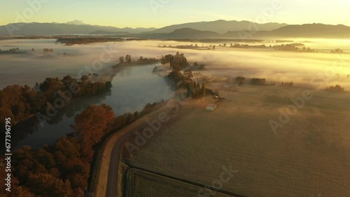 Dramatic Aerial Sunrise Over the Skagit Valley on a Foggy Morning.  Autumn in the Skagit Valley means ground fog adding to the atmospheric feeling in this agricultural area of western Washington state