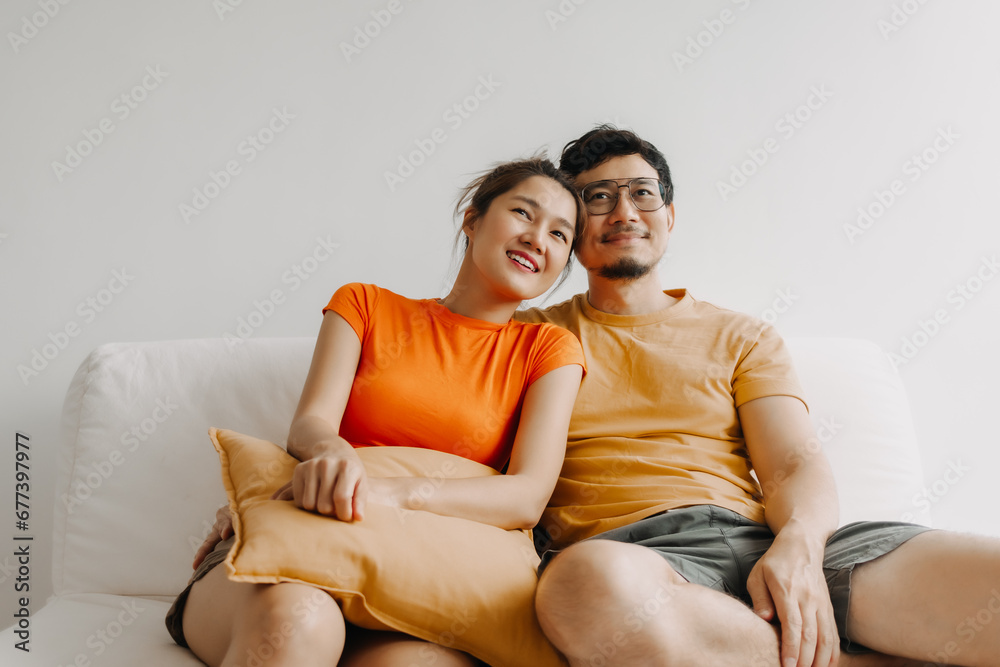 Lovely romantic asian couple watching tv movie together happy vibes weekends Lovely romantic asian couple watching tv movie together happy vibes weekends