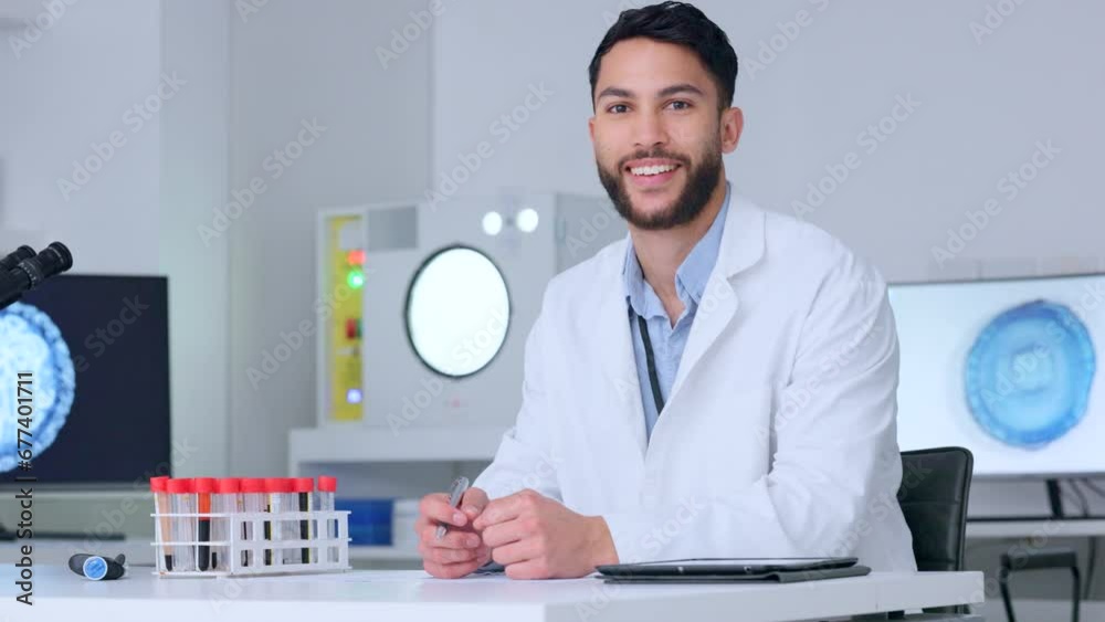 Medical science lab assistant working on new medicine drug. A young microbiologist, scientist or health professional man wearing a white coat writes research results on paper and smiles at the camera Medical science lab assistant working on new medicine drug. A young microbiologist, scientist or health professional man wearing a white coat writes research results on paper and smiles at the camera