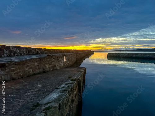 St Andrews, Scotland - September 22, 2023: Views of the buildings, vessels, breakwater and marina in St Andrews Scotland at sunrise 