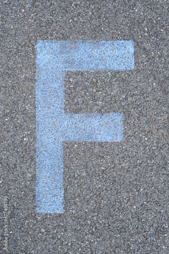 the Letter F are drawn with color paint on asphalt. a children's playground designed a creative display of the alphabet educational element learning space.