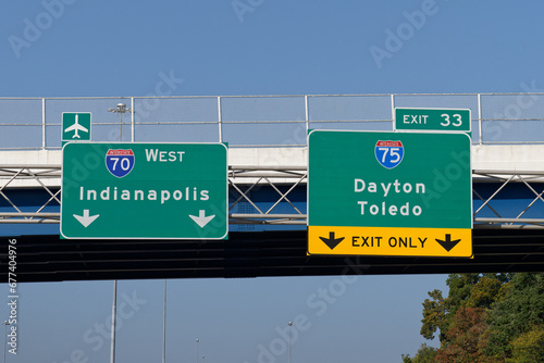 Signs on Interstate 70 for continuing west toward Indianapolis and the Dayton International Airport and exit 33 for Interstate 75 toward Dayton and Toledo, Ohio photo