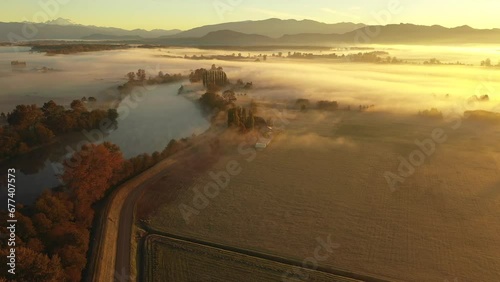 Dramatic Aerial Sunrise Over the Skagit Valley on a Foggy Morning.  Autumn in the Skagit Valley means ground fog adding to the atmospheric feeling in this agricultural area of western Washington state