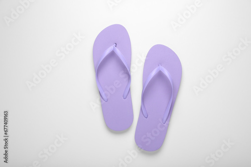 Stylish violet flip flops on white background, top view
