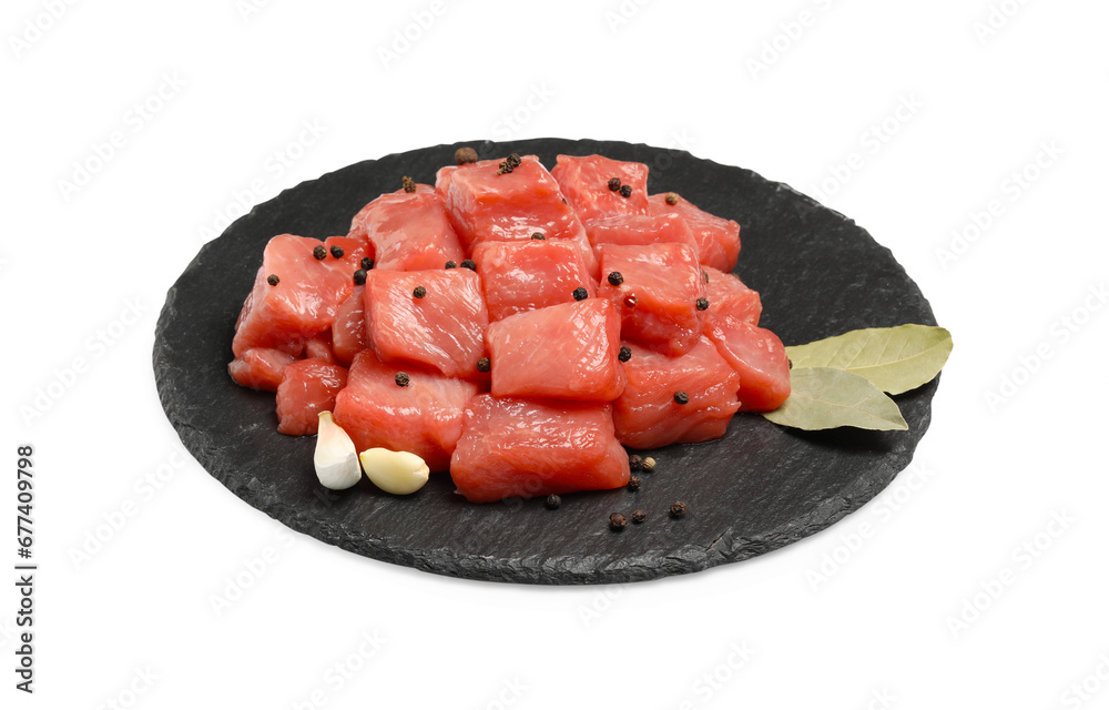 Pieces of raw beef, garlic, bay leaves and peppercorns isolated on white