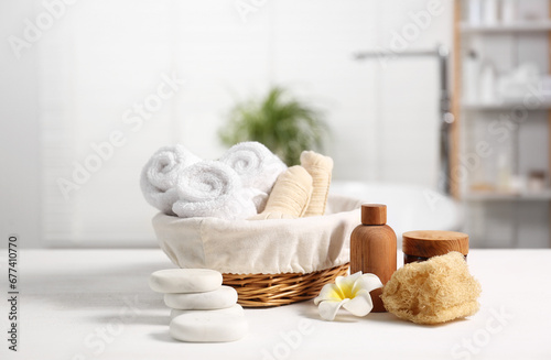 Composition with spa products on white wooden table in bathroom