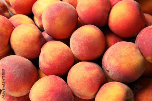 Many fresh peaches as background  top view