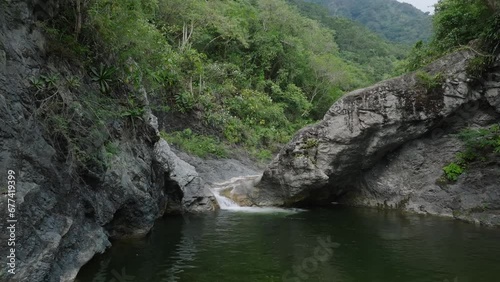 Water flows through the Rocky Canyons in Salto Las Yayitas, El Recodo, Bani, Dominican Republic, Peravia Province. Drone Shot. photo