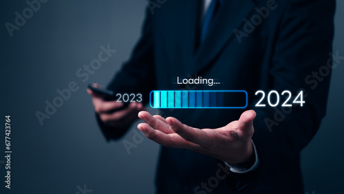 loading progress bar to 2024 Businessman using mobile phone investment and planning marketing finance and target growth success.