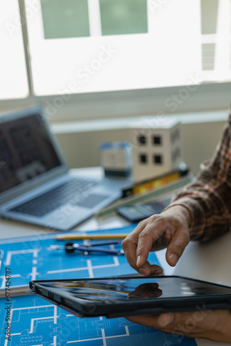 architects hands drawing of modern house with material sample on creative desk Architect Engineer Design Working on Blueprint Planning Concept. Construction Concept