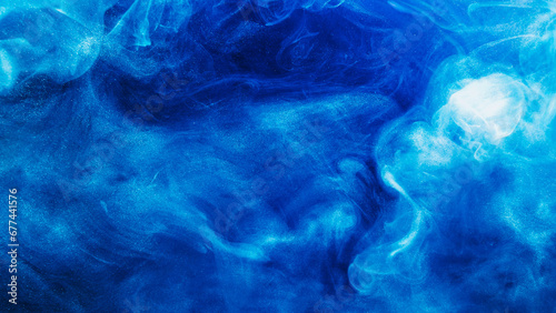 Ethereal smoke background. Mysterious cloud. Blue white paint glitter particles swirls stream wave flow in water liquid pantone ink abstract art.