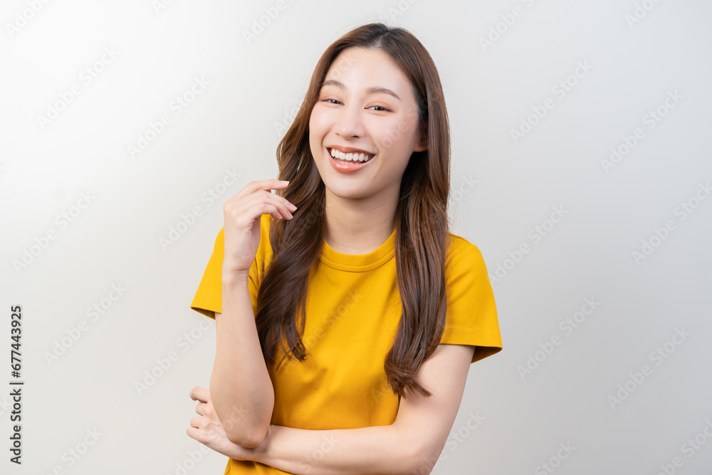 Smile positive, attractive asian young woman wearing yellow casual, portrait of beautiful brunette her with long hair, cute girl feeling happy, standing cross arms chest isolated on white background. Smile positive, attractive asian young woman wearing yellow casual, portrait of beautiful brunette her with long hair, cute girl feeling happy, standing cross arms chest isolated on white background.