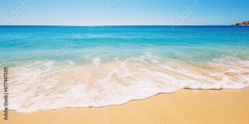 a beach with blue water and blue sky