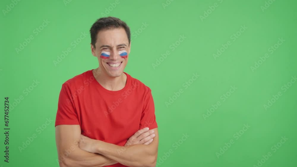 Man standing with russian flag painted on face smiling Man standing with russian flag painted on face smiling
