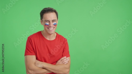Man standing with russian flag painted on face smiling photo