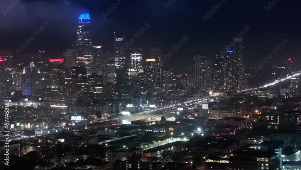 Aerial views of traffic multi levered highway California USA. Cinematic panorama of night San Francisco downtown at night illumination. Scenic views of modern contemporary city with night illumination Aerial views of traffic multi levered highway California USA. Cinematic panorama of night San Francisco downtown at night illumination. Scenic views of modern contemporary city with night illumination