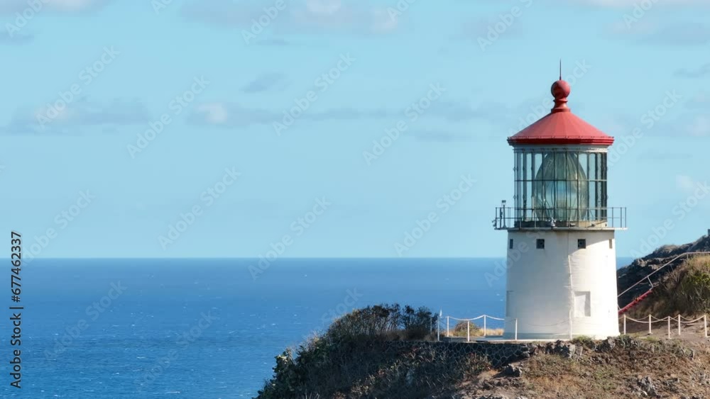 Closeup Makapuu Point Lighthouse. Scenic aerial of historical building of lighthouse on steep bluff cliff raising above blue Pacific ocean. USA travel destination aerial 4K.Oahu Hawaii tropical island Closeup Makapuu Point Lighthouse. Scenic aerial of historical building of lighthouse on steep bluff cliff raising above blue Pacific ocean. USA travel destination aerial 4K.Oahu Hawaii tropical island