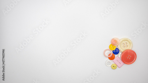 Advertising image of colored buttons with negative space on the left.