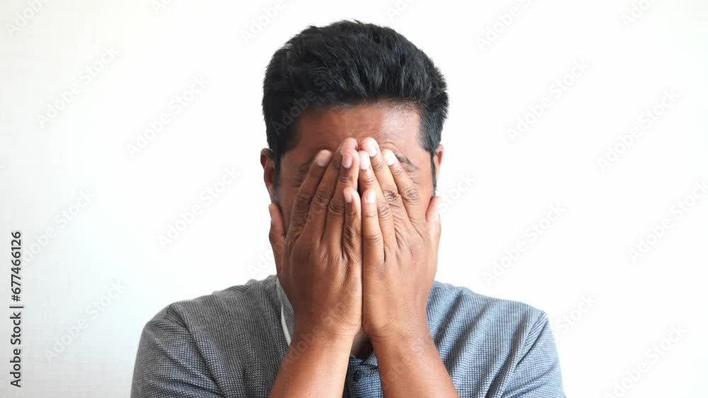 Close up of sad man covering face with hand. Close up of sad man covering face with hand.