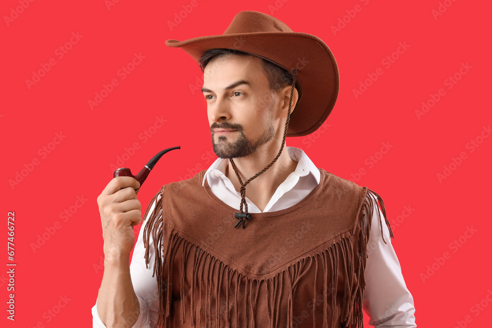 Handsome cowboy with smoking pipe on red background, closeup Handsome cowboy with smoking pipe on red background, closeup