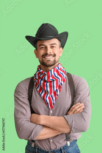 Handsome cowboy on green ba...