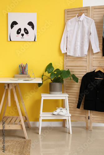 Interior of modern room with workplace and stylish school uniform © Pixel-Shot