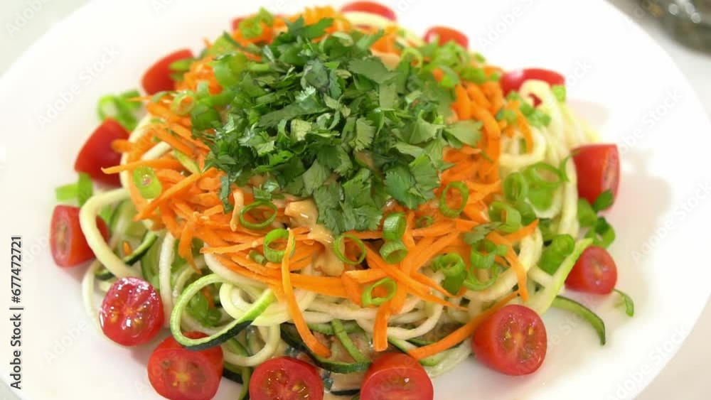 Top view shot of zucchini spiralizer on lazy susan shredded carrots sliced tomatoes Top view shot of zucchini spiralizer on lazy susan shredded carrots sliced tomatoes