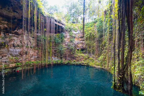 Ik-Kil Cenote - Lovely cenote in Yucatan Peninsulla with transparent waters and hanging roots. Chichen Itza, Mexico photo