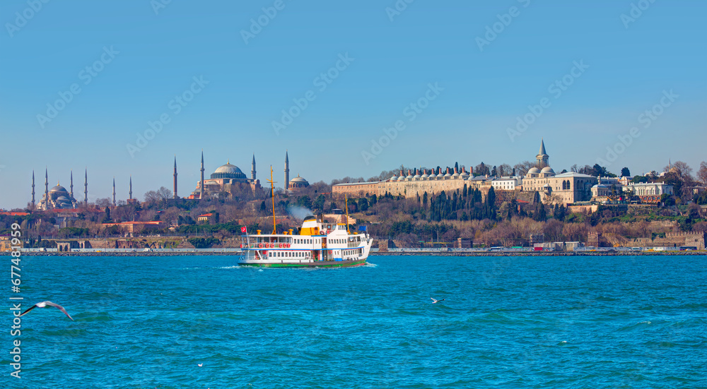 Famous historical peninsula of Istanbul - Hagia sophia, Sultanahmet Mosque - Istanbul, Turkey - Water trail foaming behind a passenger ferry boat - Bosphorus, Istanbul