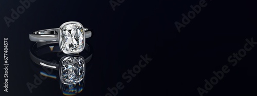 Cushion cut diamond ring on black glossy background. Wide image.