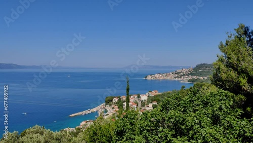 Moving shot from top of Croatian coast with town Živogošće in the background. photo