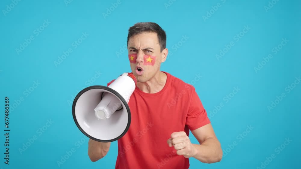 Excited man with vietnamese flag on face using a megaphone Excited man with vietnamese flag on face using a megaphone