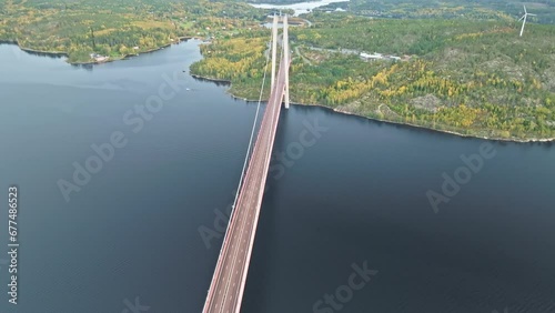 Overflying Hogakustenbron Metal And Concrete Bridge With Autumn Forest Backdrop In Sweden. Aerial Shot photo