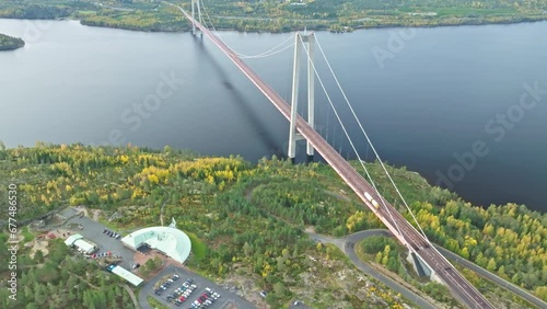 Impressive Structure Of Hogakustenbron Bridge In Sweden. Calm Sea And Autumn Forest Seen From Above. Aerial Shot photo