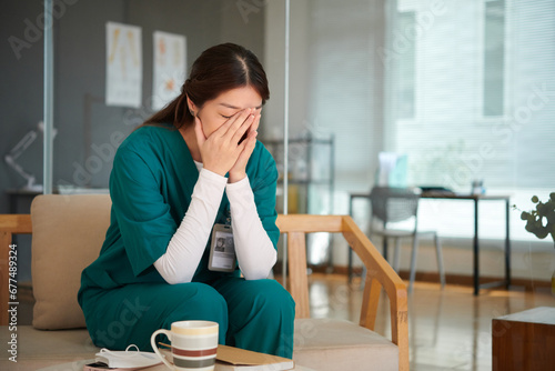 Photography Medical nurse sitting on bench in lounge area and crying after loosing patient