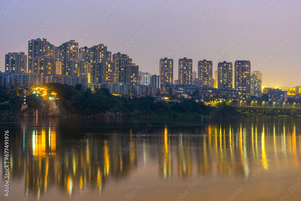 Naklejka premium View of Chongqing skyline from Ciqikou Ancient Town during evening and night at Chongqing Yuzhong District , China : 23 October 2023