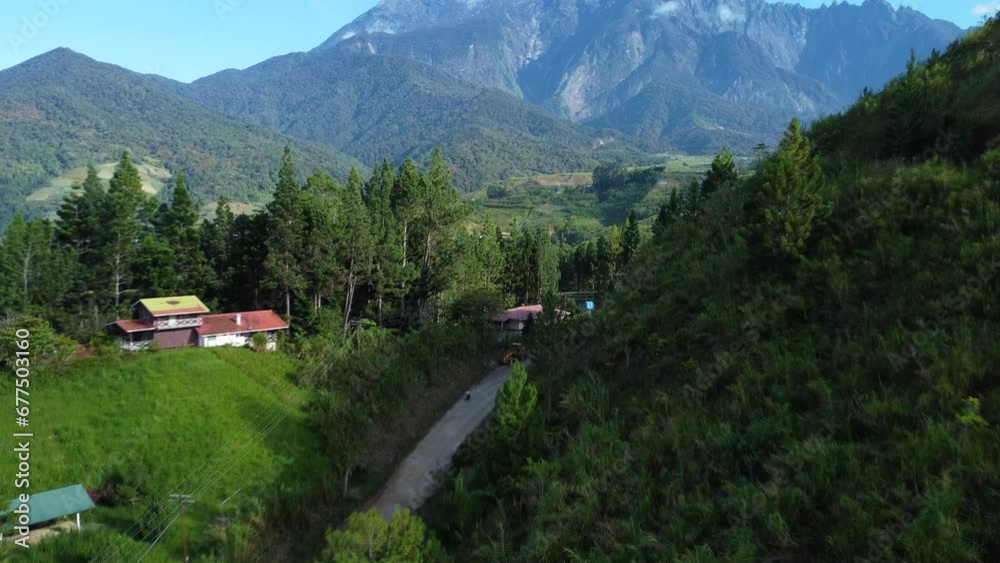 Beautiful tilt Drone shot of the road to Mount Kinabalu at Kundasnag Sabah Malaysia daylight