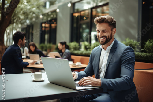 Successful business man using a laptop in a meeting with his colleague © alisaaa