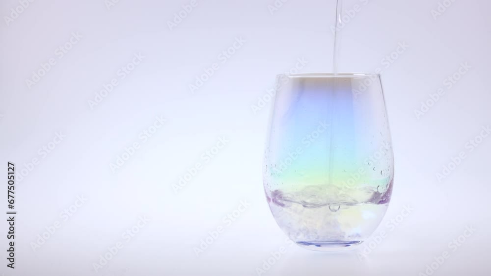 Pour water into a glass cup. White background - with sound Pour water into a glass cup. White background - with sound
