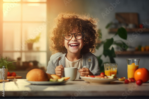 a smiling little girl having breakfast in kitchen photo