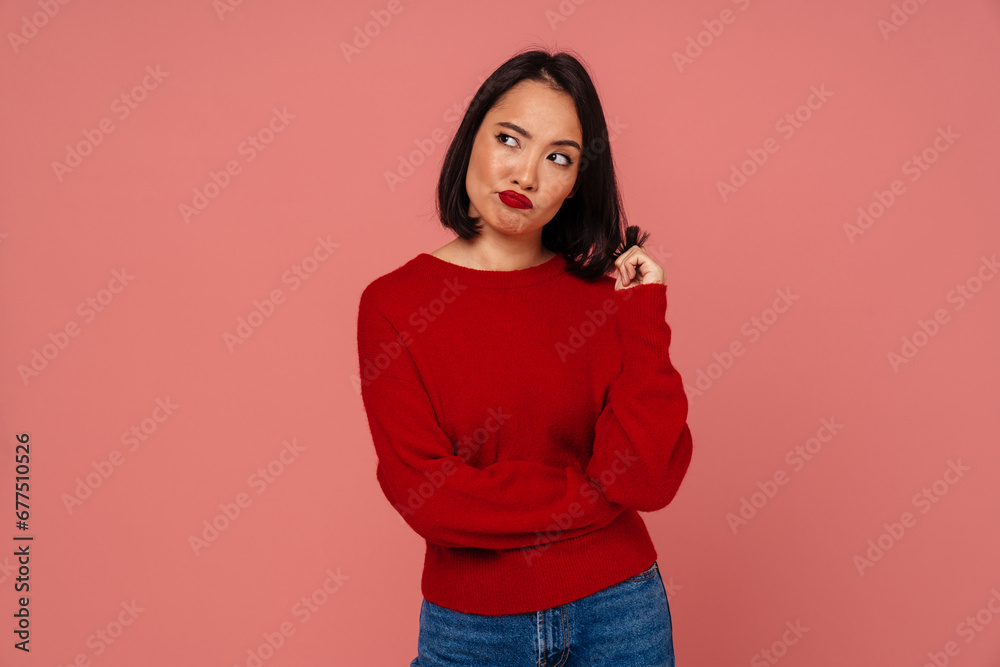 Upset woman standing isolated over pink wall Upset woman standing isolated over pink wall