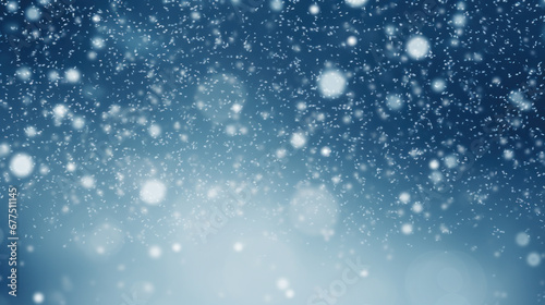 Snowfall against a blurred blue background. photo