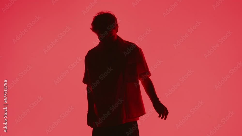 Man Dancing Against Red Backdrop Man Dancing Against Red Backdrop