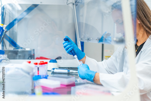 Woman working in a cancer research laboratory photo