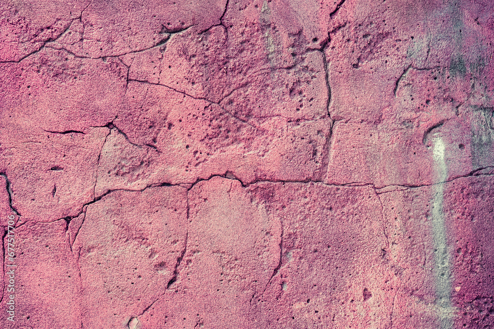An elderly weathered brick wall with cracked textured pink pattern.