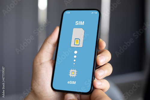 male hands hold phone with Sim card replacement on eSim