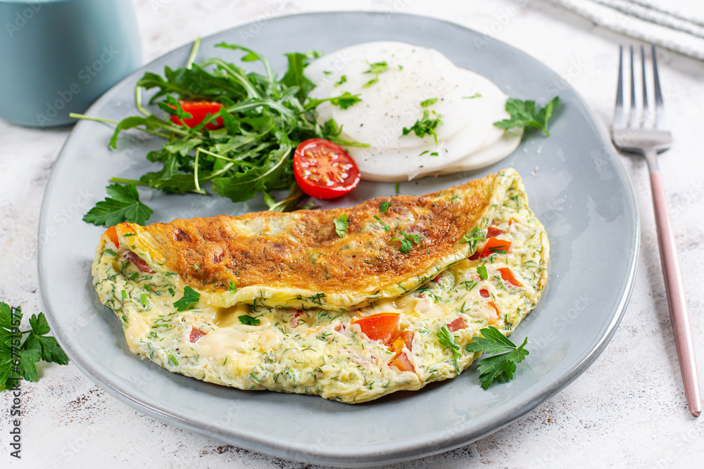 Omelette with tomatoes and salad on plate. Frittata - italian omelet. Keto, ketogenic diet. Omelette with tomatoes and salad on plate. Frittata - italian omelet. Keto, ketogenic diet.