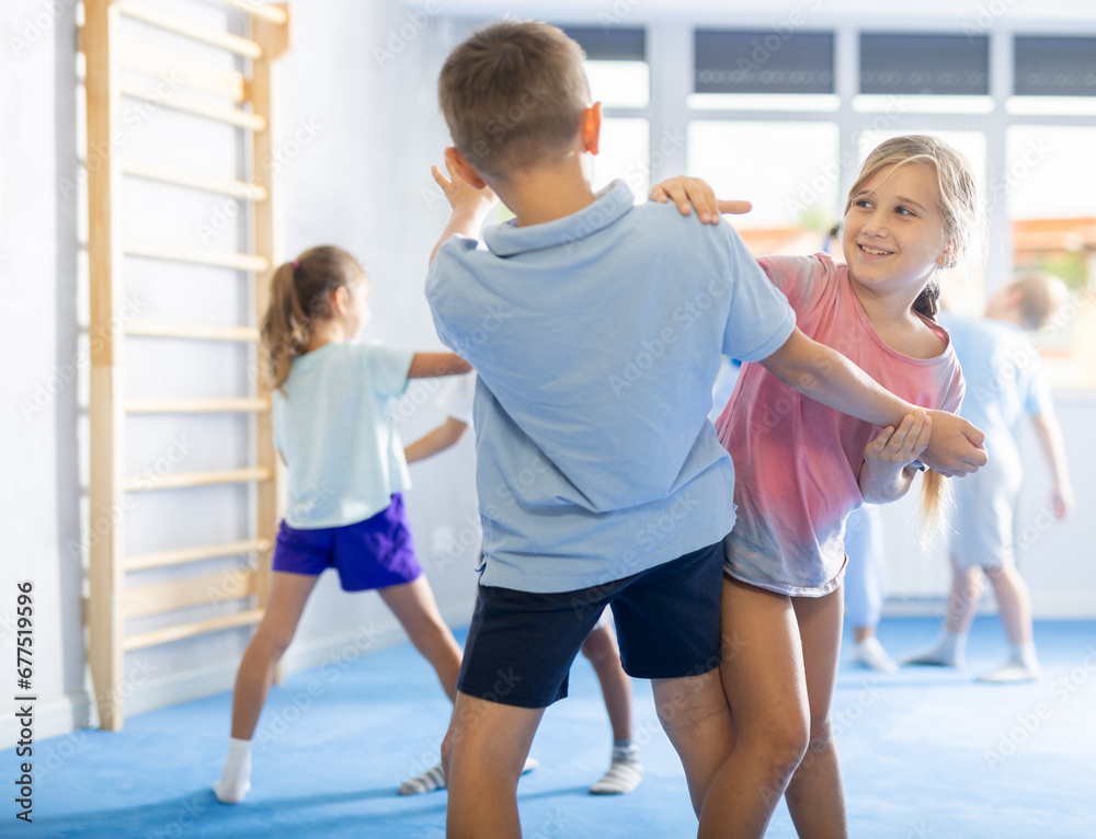 Children train in pairs to strike and reflect blows of enemy. Self-defense training and Krav Maga principles