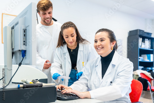 Three young doctors working in a scholarship in a laboratory photo
