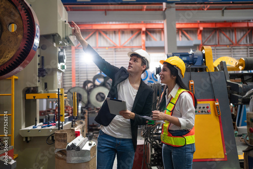 Schilderij op canvas Chief Engineer and Project Manager Wearing Safety Vests and Hard Hats, Use Digital Tablet Computer in Modern Factory, Talking and planning optimization of production at industrial factory